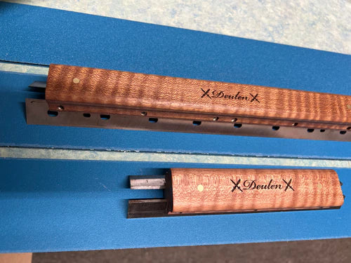 Two wooden sharpeners with 'Deuden' branding on a blue background