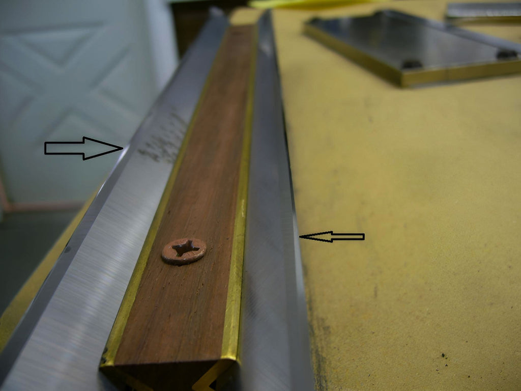 Metal frame with wooden strip and screw on a yellow surface